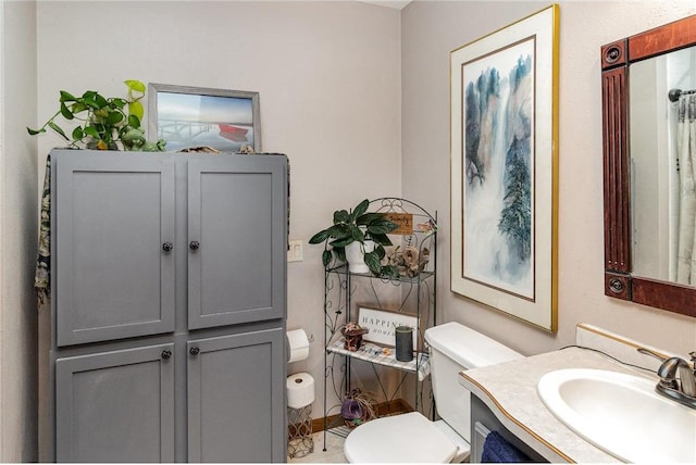 bathroom featuring vanity and toilet