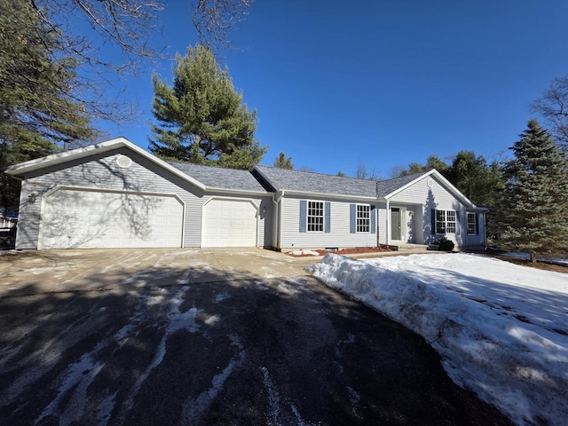 ranch-style home with driveway and an attached garage