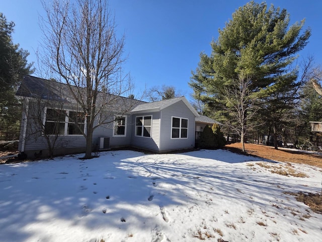 view of snow covered back of property