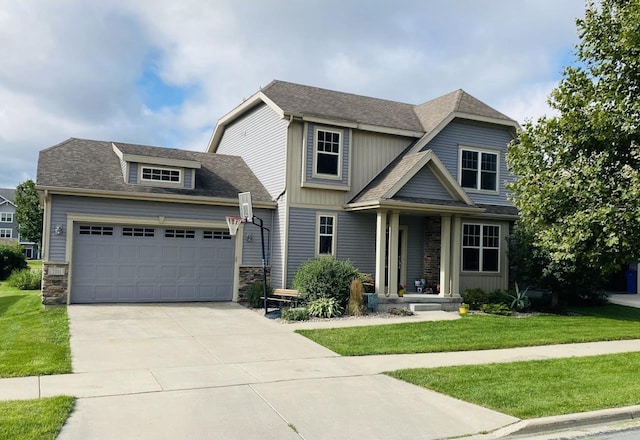 craftsman house featuring an attached garage, stone siding, concrete driveway, and a front yard