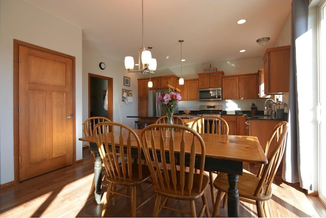 dining room featuring a chandelier, light wood-type flooring, and recessed lighting