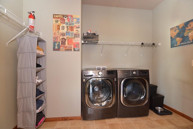 laundry room featuring laundry area, baseboards, and washer and clothes dryer