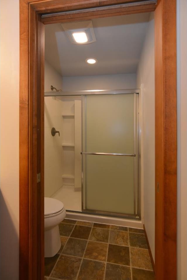 full bath featuring toilet and a stall shower