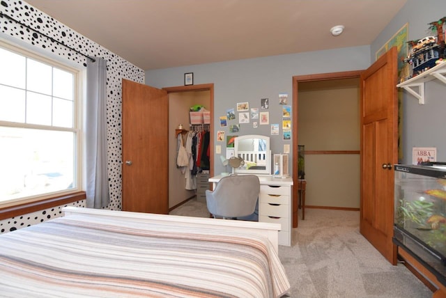 bedroom featuring a closet and light colored carpet