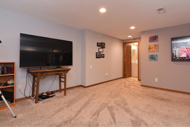 carpeted living area featuring visible vents, baseboards, and recessed lighting