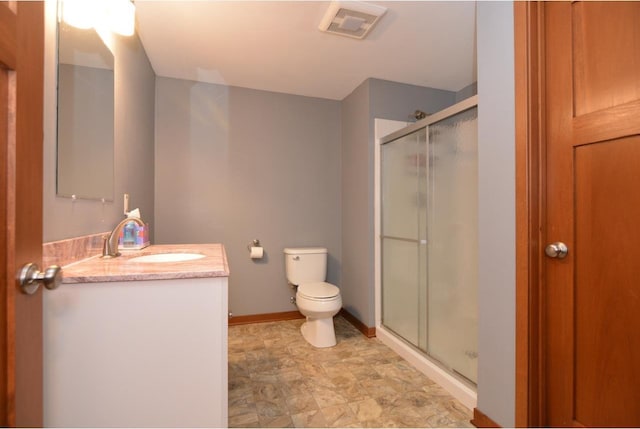 bathroom with visible vents, toilet, a stall shower, vanity, and baseboards