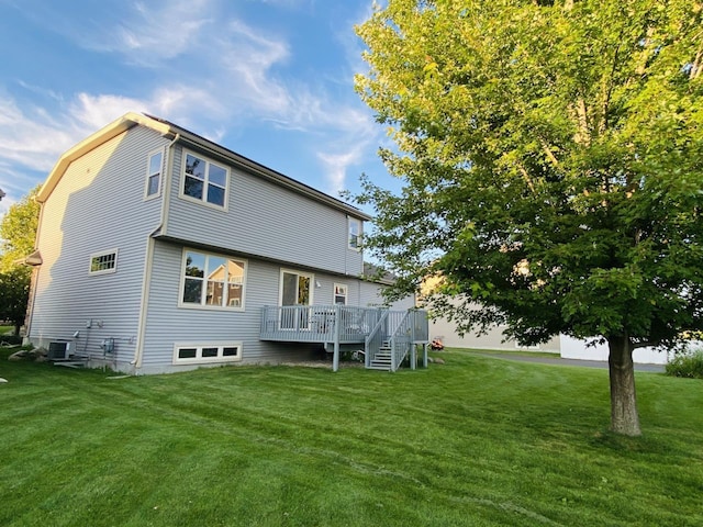 rear view of house featuring a deck, a lawn, and central air condition unit