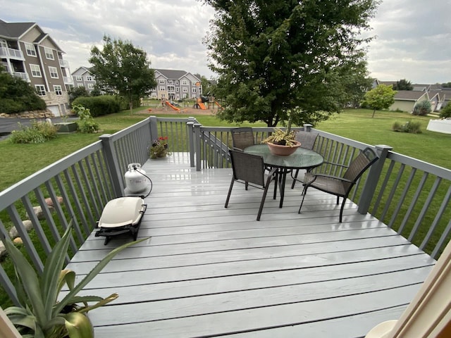 wooden deck featuring a residential view and a lawn