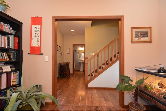 hall with stairs and wood finished floors