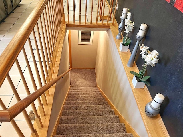 stairs featuring carpet and baseboards