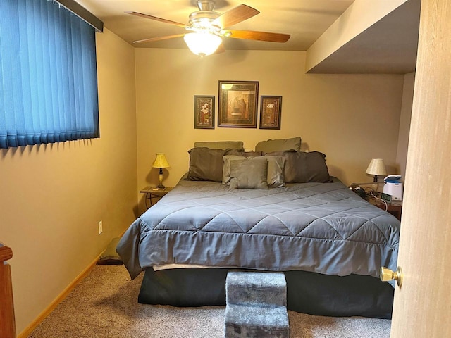 carpeted bedroom with baseboards and a ceiling fan