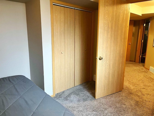 bedroom featuring carpet, a closet, and visible vents