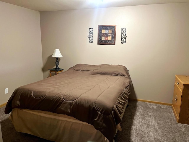 bedroom with carpet floors and baseboards