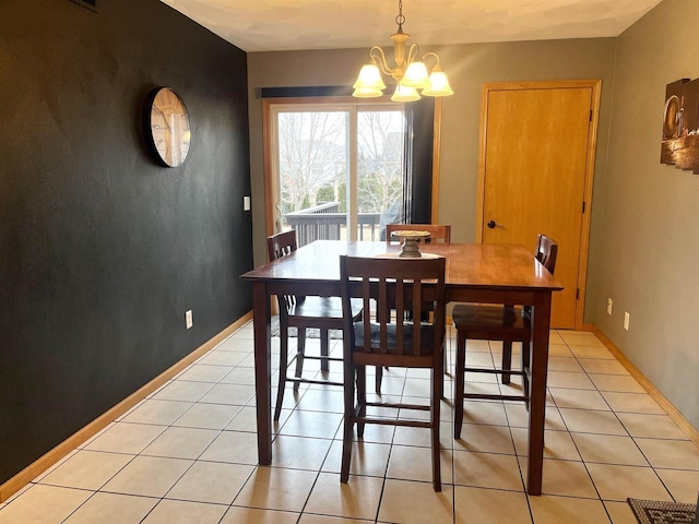 dining space featuring a chandelier, baseboards, and light tile patterned floors