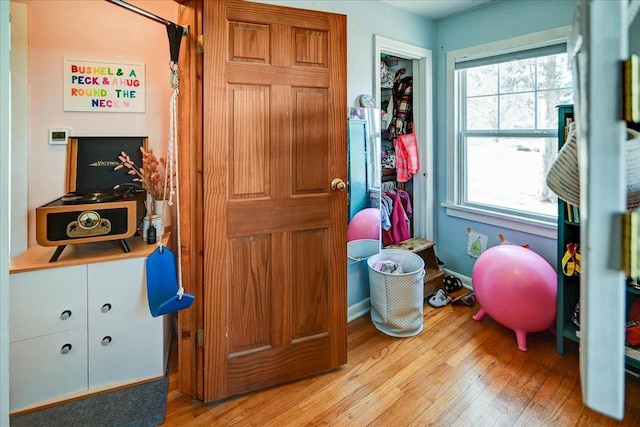 interior space featuring baseboards and light wood-style flooring