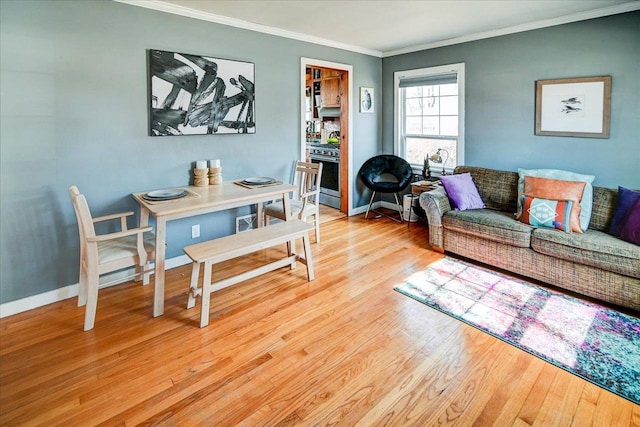 living room featuring crown molding, wood finished floors, and baseboards