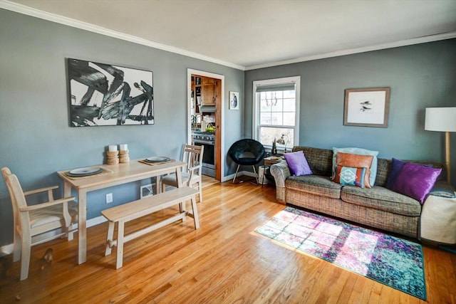 living room with ornamental molding, baseboards, and wood finished floors