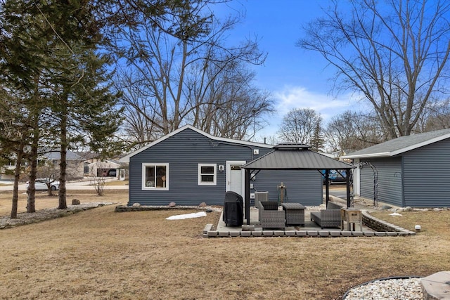 back of property featuring a yard, an outdoor hangout area, and a patio