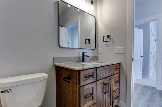 bathroom featuring toilet and vanity