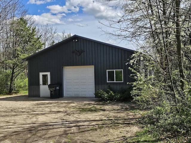 detached garage with dirt driveway