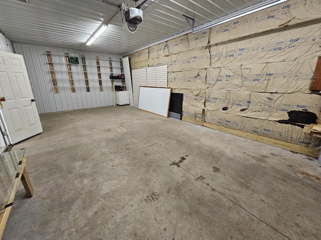 garage featuring metal wall and a garage door opener