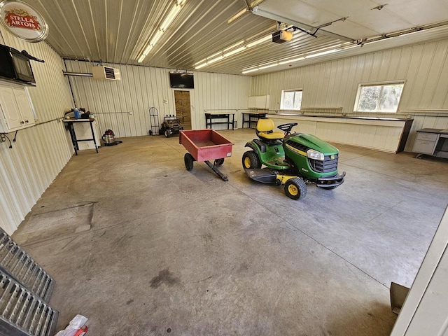 garage featuring metal wall and a garage door opener