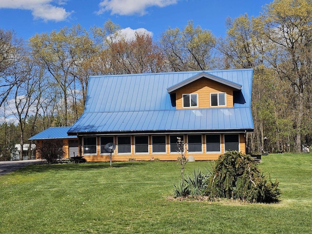 view of front facade featuring a front yard and metal roof