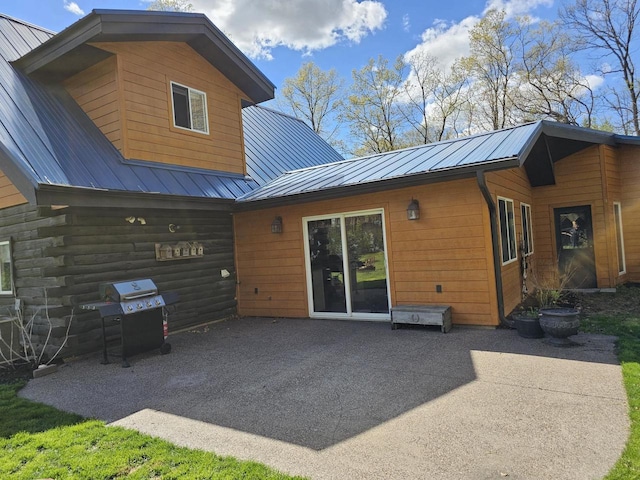 back of house featuring a patio area and metal roof