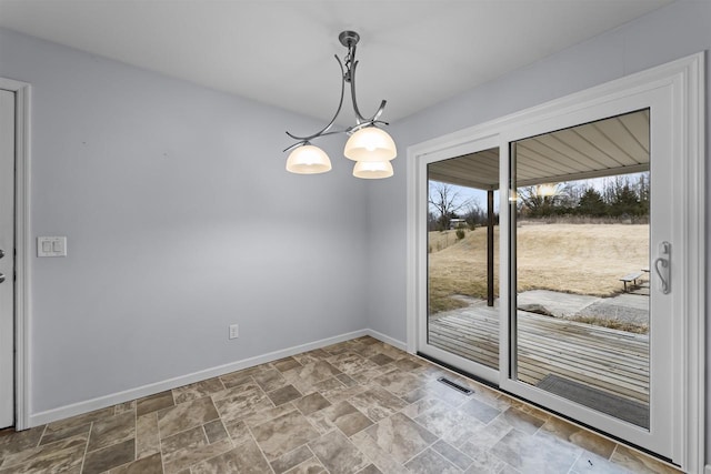 interior space with visible vents, stone finish floor, a wealth of natural light, and baseboards