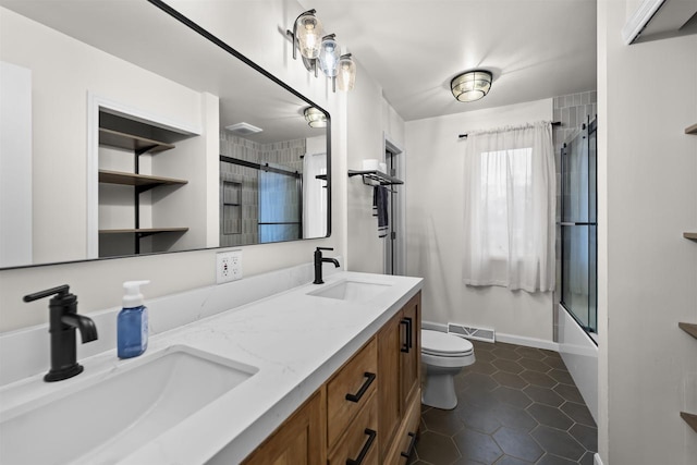 bathroom featuring visible vents, a sink, toilet, and tile patterned floors