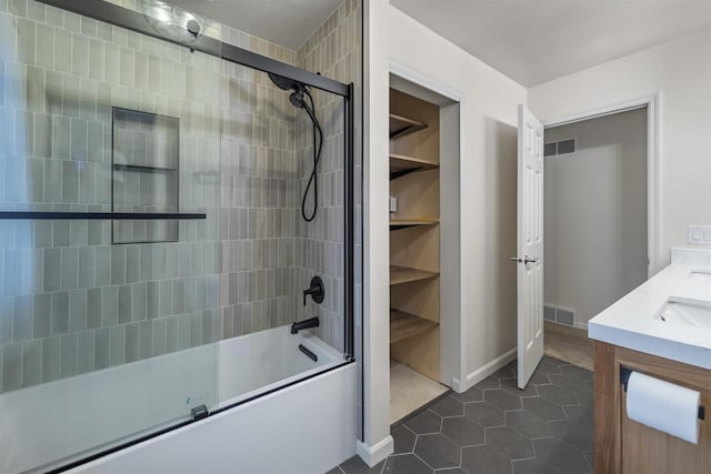 full bath featuring enclosed tub / shower combo, visible vents, a sink, and tile patterned floors