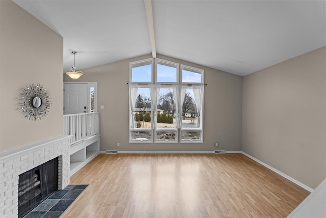 unfurnished living room featuring a fireplace, baseboards, and wood finished floors