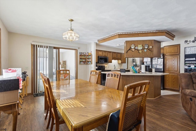 dining space featuring a chandelier and wood finished floors