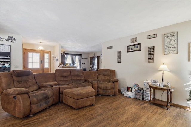 living room featuring visible vents and wood finished floors