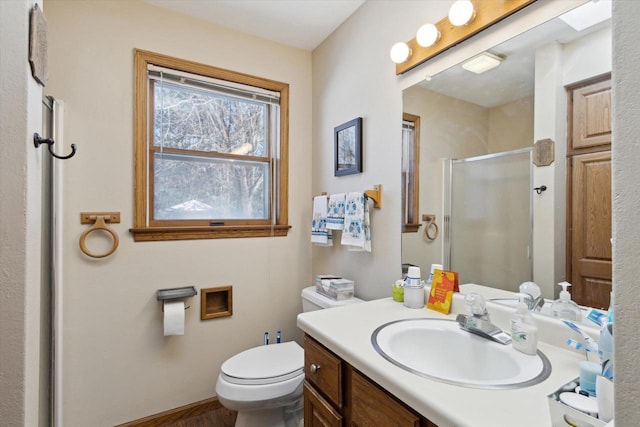 full bath featuring a stall shower, baseboards, vanity, and toilet