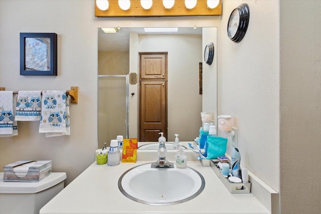 bathroom featuring an enclosed shower and vanity