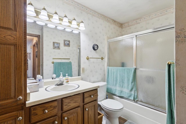 full bathroom featuring toilet, shower / bath combination with glass door, vanity, and wallpapered walls