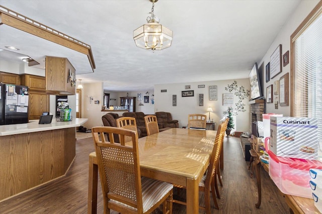 dining area featuring a chandelier and dark wood finished floors