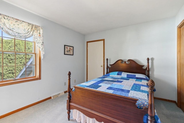 carpeted bedroom featuring baseboards and visible vents