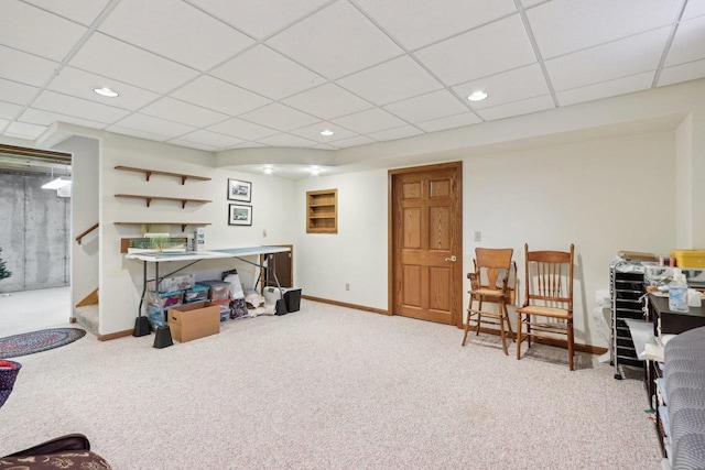 interior space featuring baseboards, a drop ceiling, stairs, carpet flooring, and recessed lighting