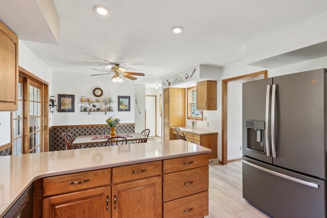 kitchen featuring brown cabinetry, ceiling fan, stainless steel appliances, light countertops, and recessed lighting