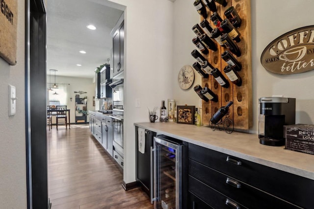 bar with a dry bar, wall oven, dark wood finished floors, wine cooler, and recessed lighting