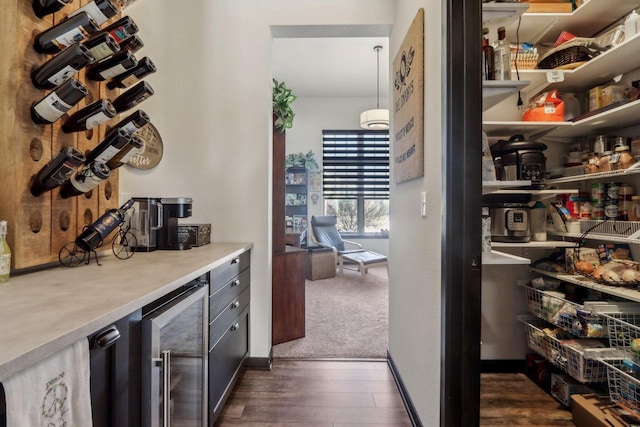 bar with dark wood-style floors and beverage cooler