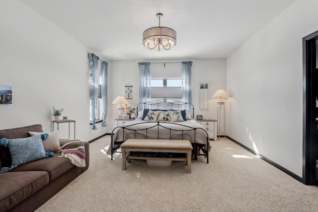 bedroom featuring light carpet and baseboards