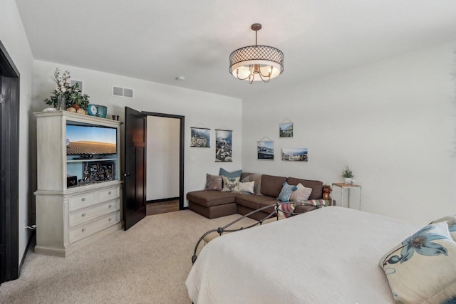 bedroom featuring visible vents and light colored carpet