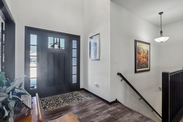 foyer featuring dark wood-type flooring and baseboards