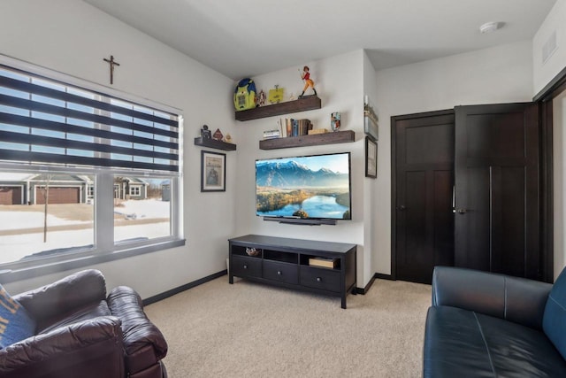 living area with light carpet, visible vents, and baseboards