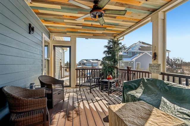 deck featuring a jacuzzi and a ceiling fan