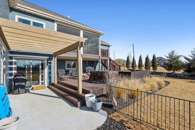 view of patio featuring fence, a deck, and stairs