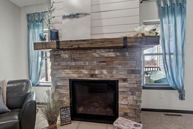 room details with baseboards and a stone fireplace